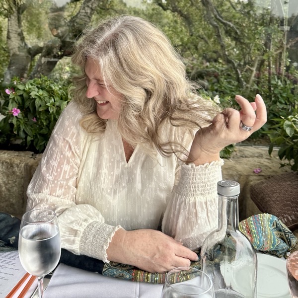 Jessica Guthrie laughing at a table in a garden setting